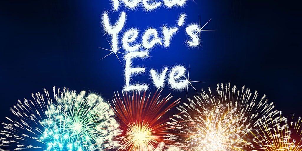 Colorful fireworks burst against a night sky with sparkling text reading ‘New Year’s Eve.