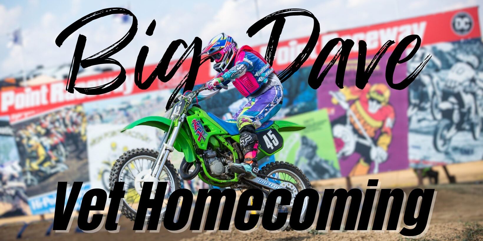 Motocross rider in colorful gear racing a green dirt bike on a track, with bold text reading “Big Dave Vet Homecoming” overlaid on the image