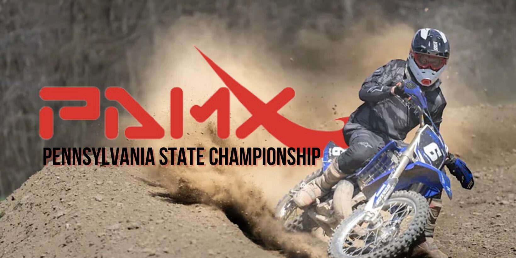 Motocross rider leaning into a turn on a dirt track, kicking up dust, with text reading ‘PAMX Pennsylvania State Championship