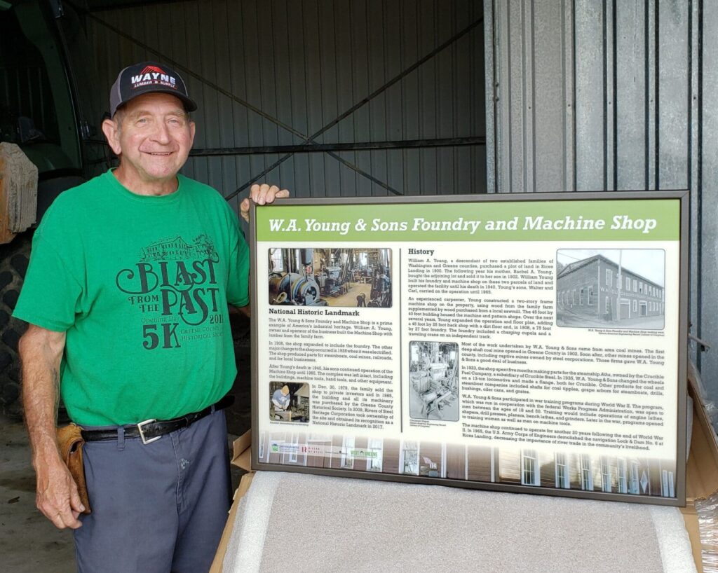 George Blystone with informational sign