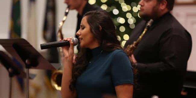 Lead singer accompanied by two brass instrument players at the WU Student Recital.