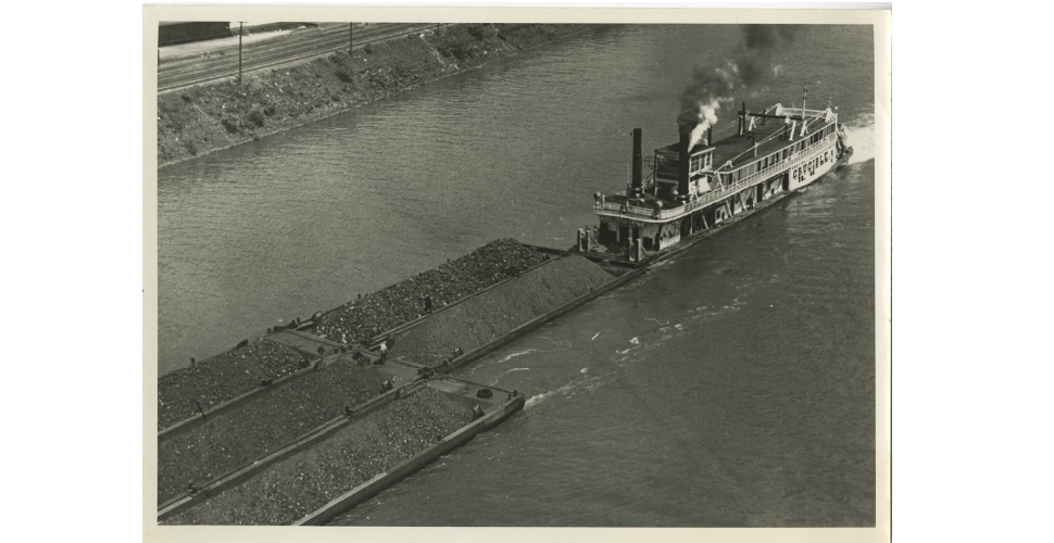 A view of the Crucible towing coal barges. The sternwheel towboat was operated by the Crucible Steel Company.