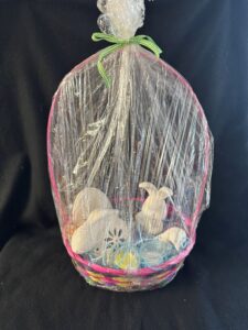 Easter basket filled with ceramic pieces for kids to paint.