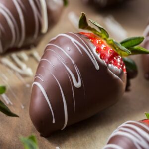 Chocolate covered strawberries drizzled with white chocolate.