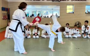 Judoka yellow belt high kicks target at the American Judo Hapkido Institute.