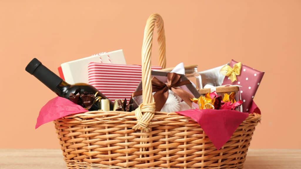 Photograph of an Easter Basket filled with wine, wrapped packages, soaps, and flowers.