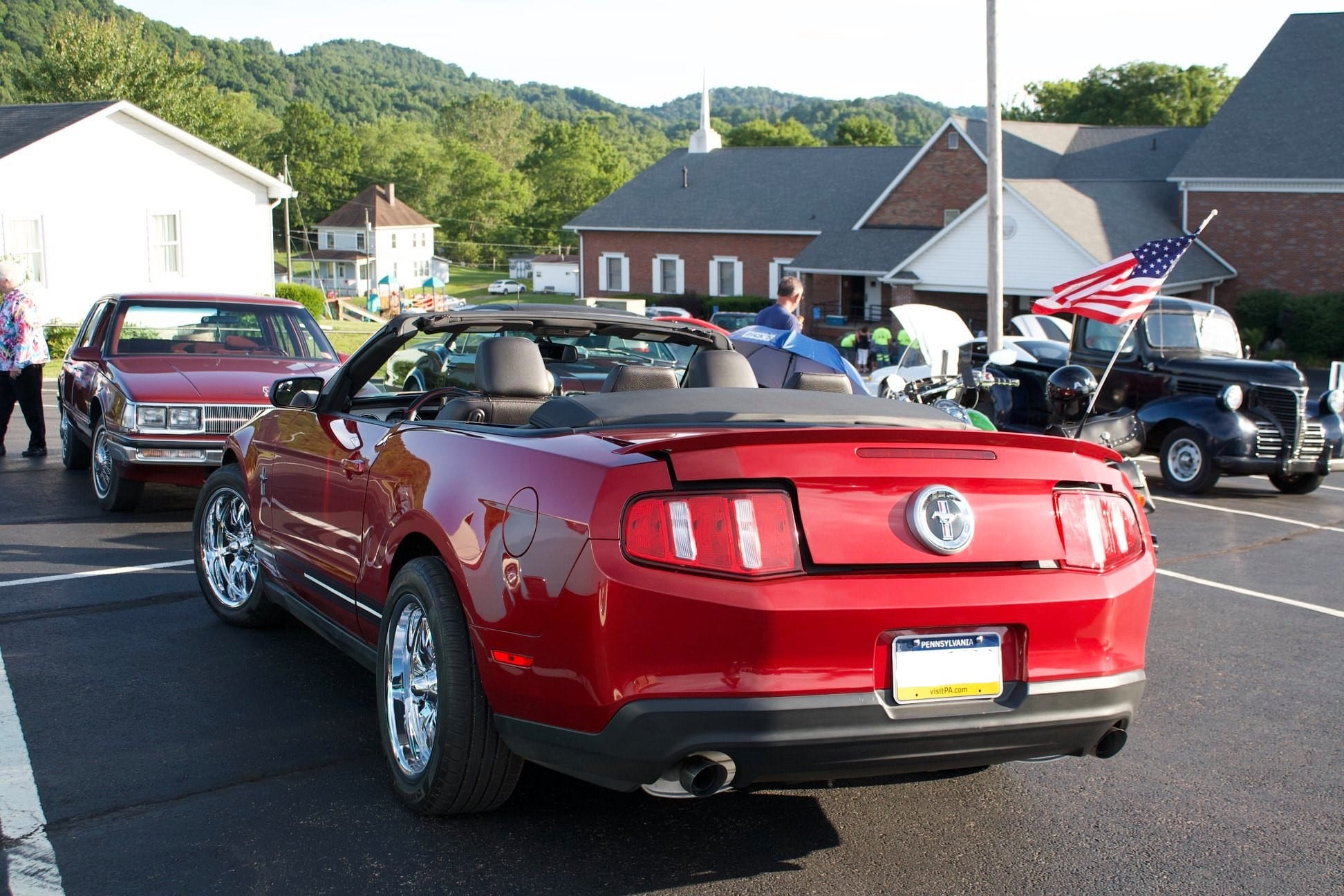 Photograph of red car in parking lot overlooking Mt. Morris.