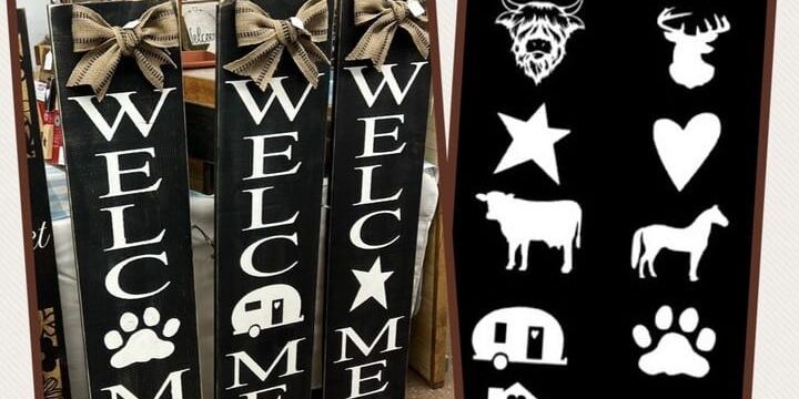 Three black vertical signs with white text of Welcome. The O is an illustration of a pawprint, camper, and star.