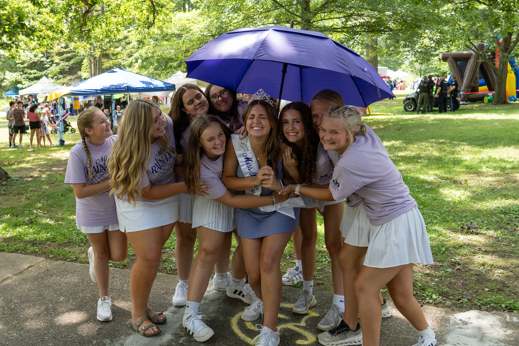 2025 Miss Rain Day Camryn Hawfield receiving a hug from the Miss Rain Day contestants.