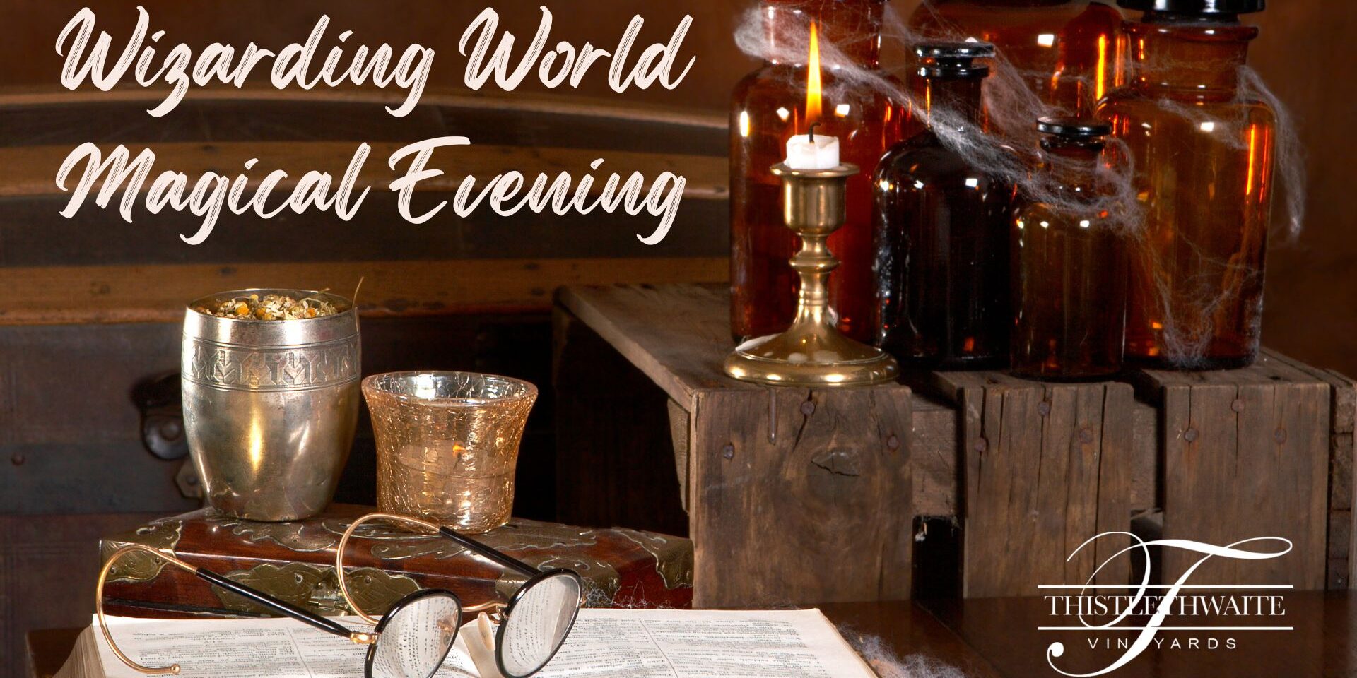 A cozy wizard-themed scene with antique glasses resting on an open book, a candle burning on a brass holder, and vintage glass potion bottles with cobwebs on wooden crates. Text reads “Wizarding World Magical Evening” with the Thistlethwaite Vineyards logo.